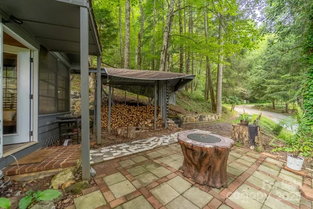 a view of a patio with table and chairs potted plants with large tree