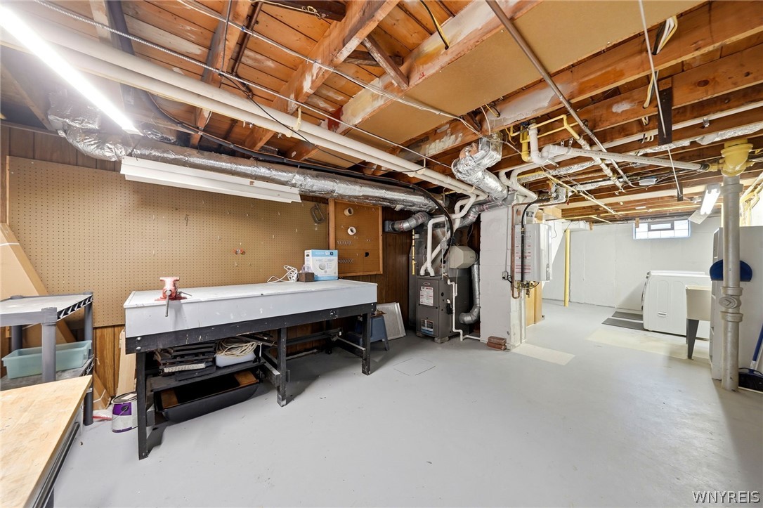 212 Treadwell Road Tonawanda, NY 14150 - Photo 26 of 39 Workbench and storage room in basement.