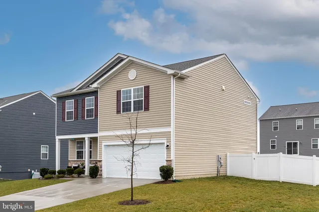 a front view of a house with garage