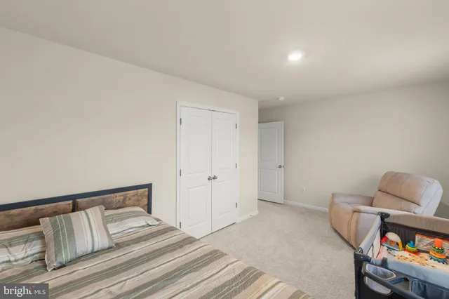 a spacious bedroom with a bed and a couch