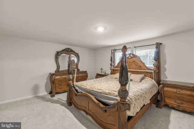 a bed sitting in a room next to a window