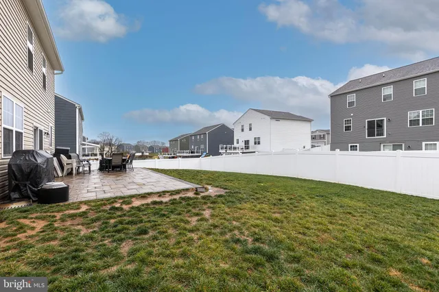 a swimming pool with outdoor seating and yard