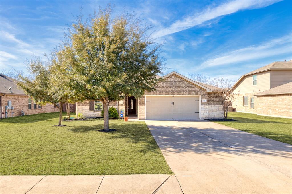 A charming single-story residence with a meticulously kept front lawn and inviting brick facade.