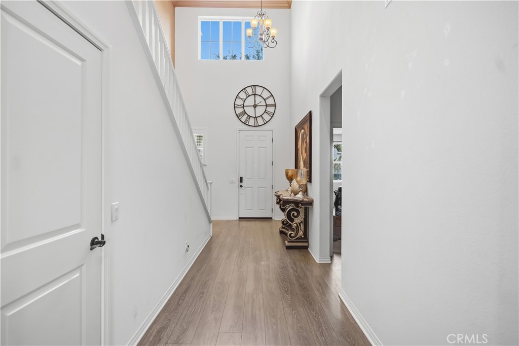 3380 Pine Ridge Loop Ontario, CA 91761 - Photo 4 of 37 a view of a hallway with wooden floor