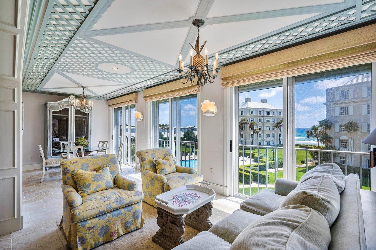 a living room with furniture and a floor to ceiling window