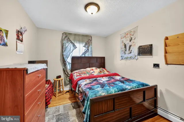 a bedroom with a bed and dresser
