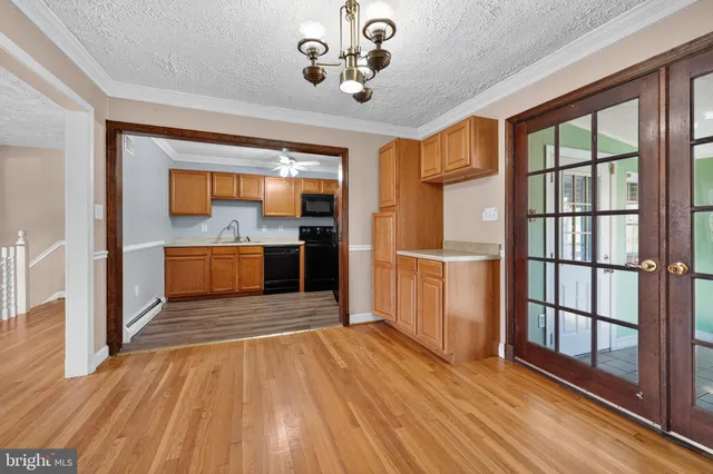 wooden floor in an empty room with a kitchen
