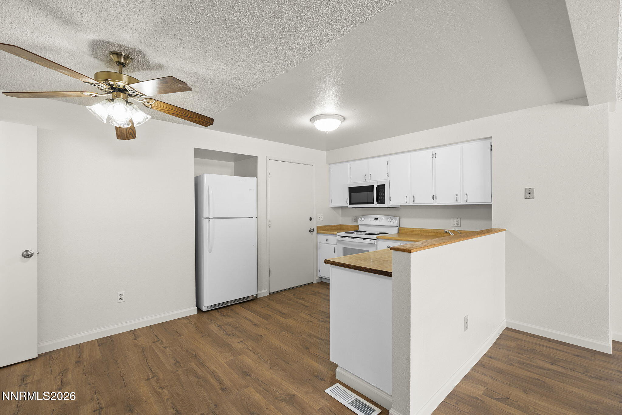 401 Allouette Way, Unit 2 Carson City, NV 89701 - Photo 11 of 29 a kitchen with a refrigerator a sink and dishwasher with wooden floor