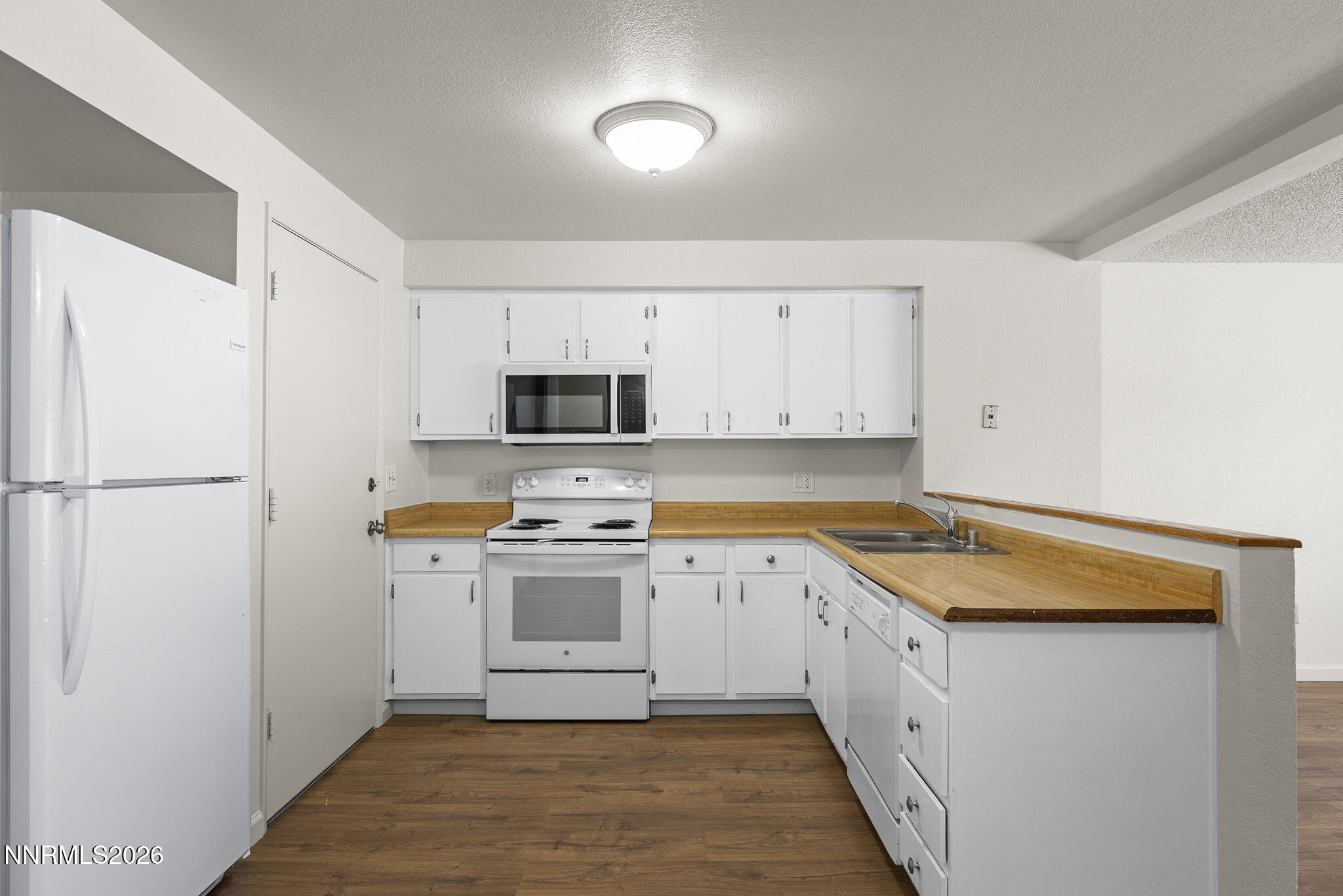 401 Allouette Way, Unit 2 Carson City, NV 89701 - Photo 13 of 29 a kitchen with stainless steel appliances granite countertop a refrigerator a stove a sink and white cabinets with wooden floor