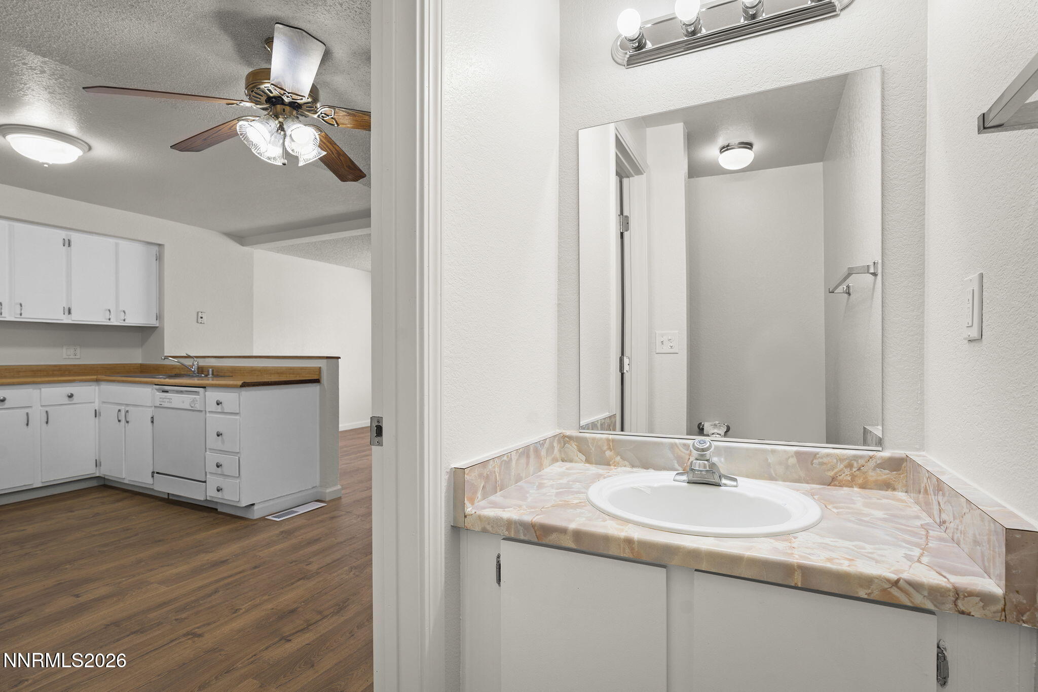 401 Allouette Way, Unit 2 Carson City, NV 89701 - Photo 15 of 29 a bathroom with a granite countertop sink a light fixture and a mirror