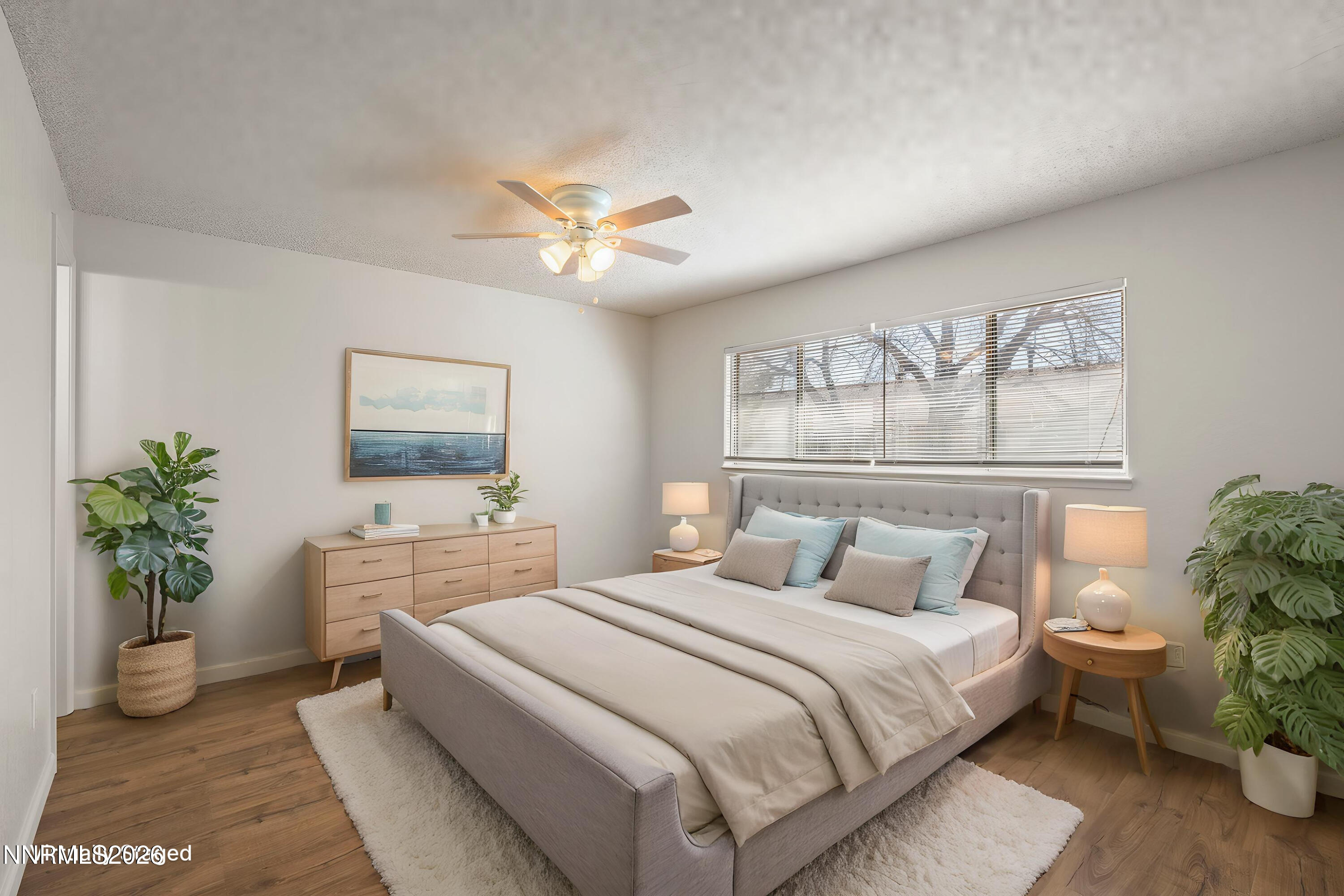 401 Allouette Way, Unit 2 Carson City, NV 89701 - Photo 16 of 29 a bedroom with a large bed and a chandelier