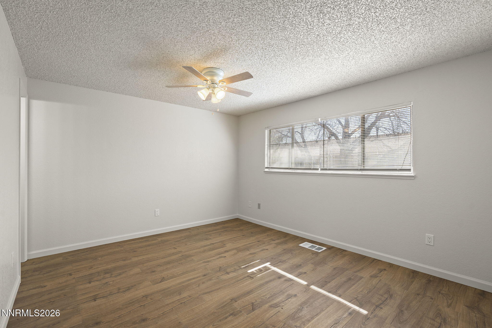 401 Allouette Way, Unit 2 Carson City, NV 89701 - Photo 17 of 29 a view of empty room with wooden floor and fan