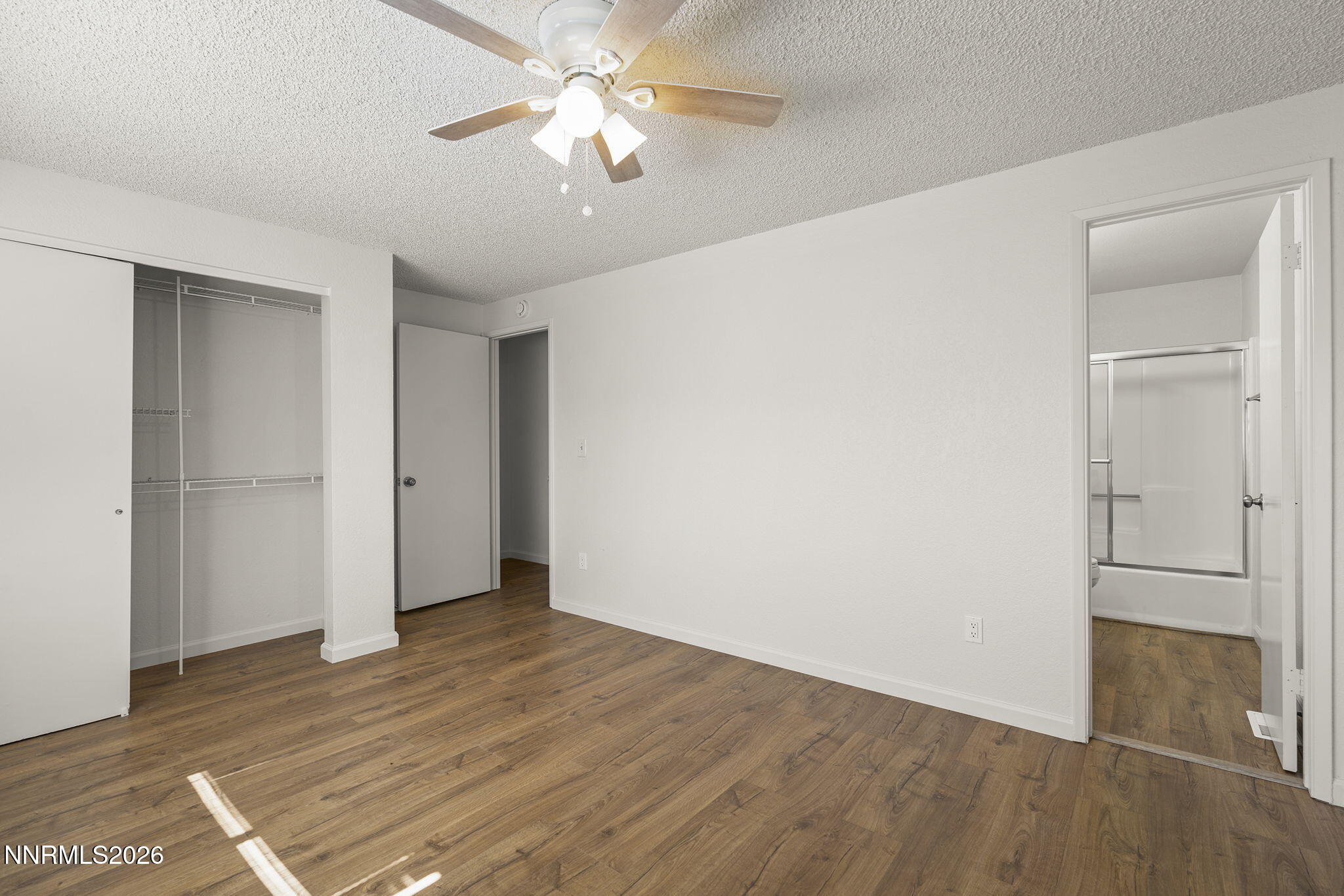 401 Allouette Way, Unit 2 Carson City, NV 89701 - Photo 18 of 29 an empty room with wooden floor and a ceiling fan