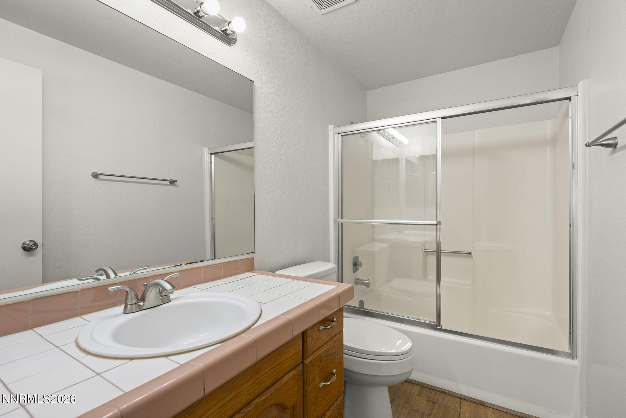 401 Allouette Way, Unit 2 Carson City, NV 89701 - Photo 19 of 29 a bathroom with a granite countertop sink toilet and a mirror
