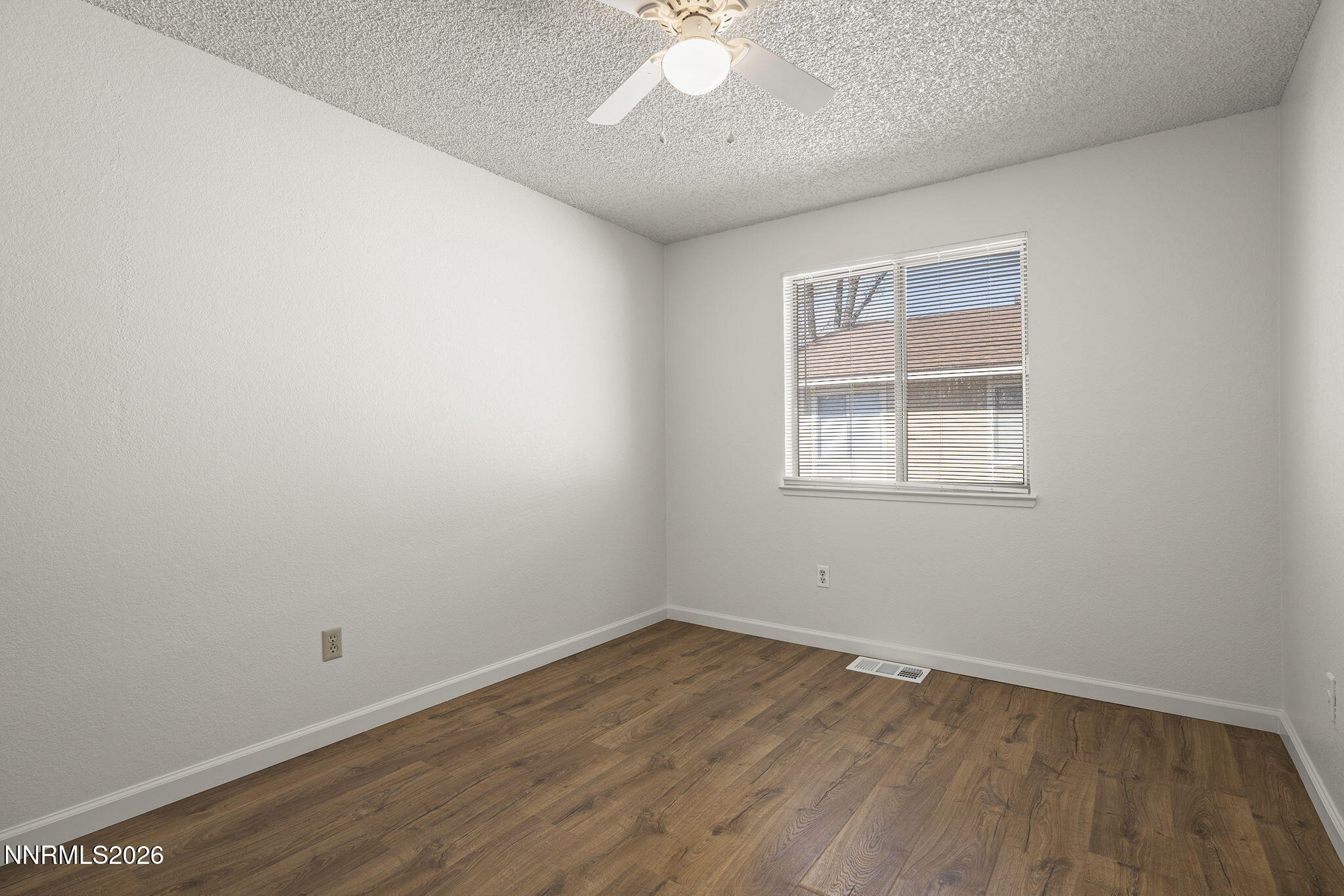 401 Allouette Way, Unit 2 Carson City, NV 89701 - Photo 21 of 29 an empty room with wooden floor and windows