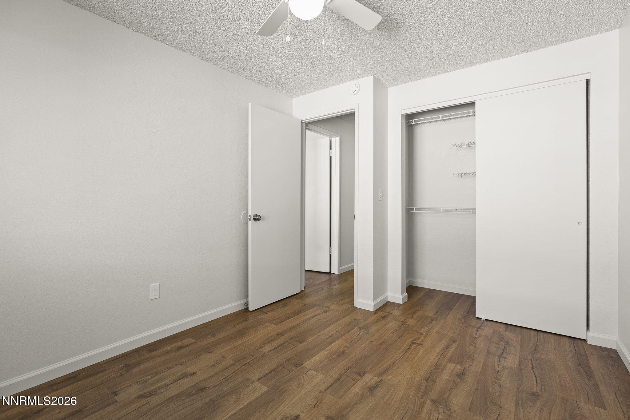 401 Allouette Way, Unit 2 Carson City, NV 89701 - Photo 22 of 29 an empty room with wooden floor and a ceiling fan
