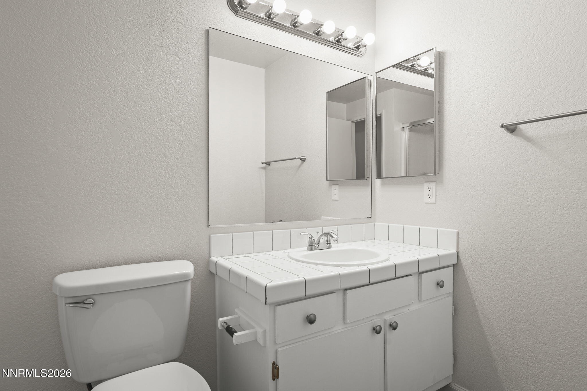 401 Allouette Way, Unit 2 Carson City, NV 89701 - Photo 25 of 29 a bathroom with a toilet sink and mirror