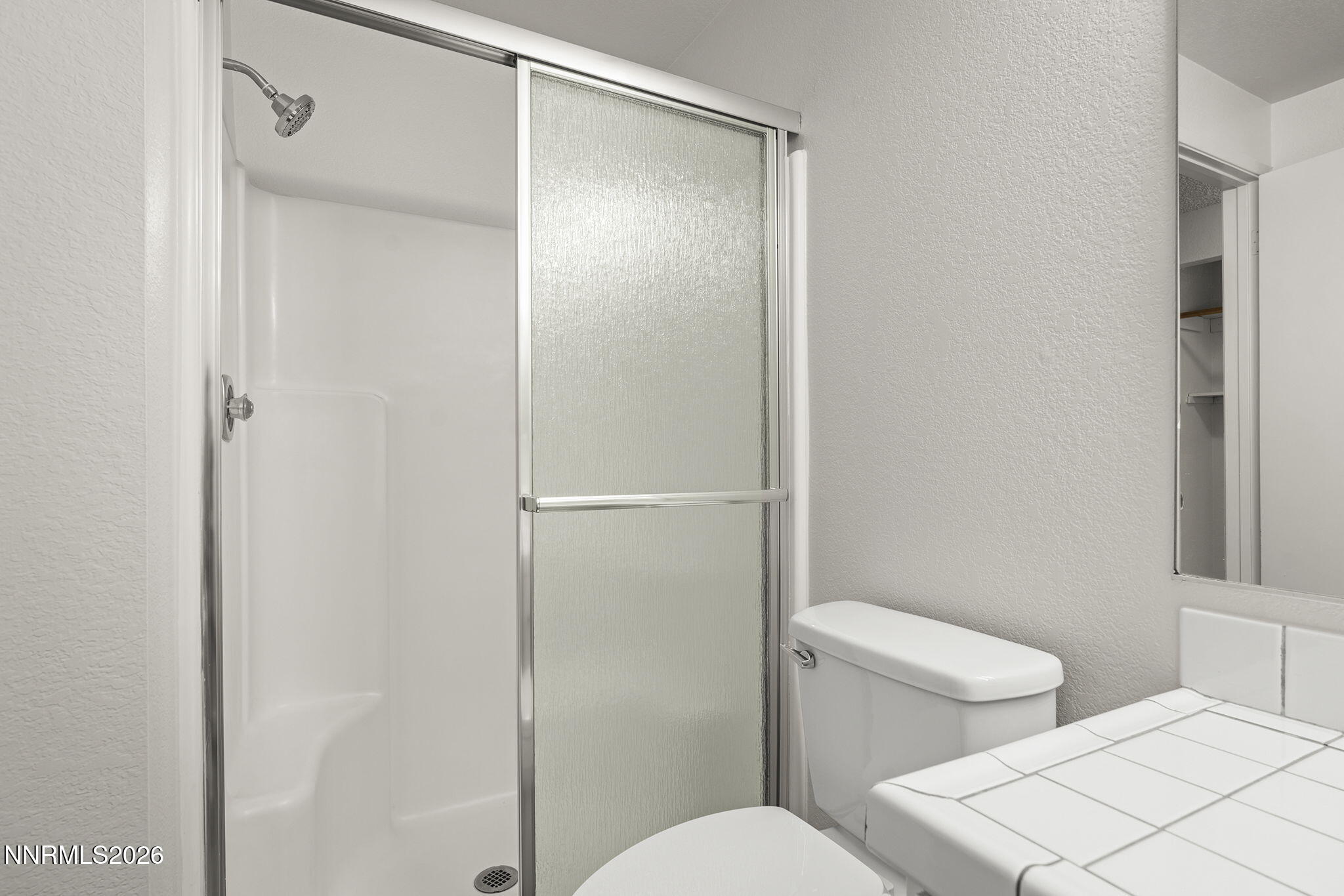401 Allouette Way, Unit 2 Carson City, NV 89701 - Photo 26 of 29 a white toilet sitting next to a bathroom sink