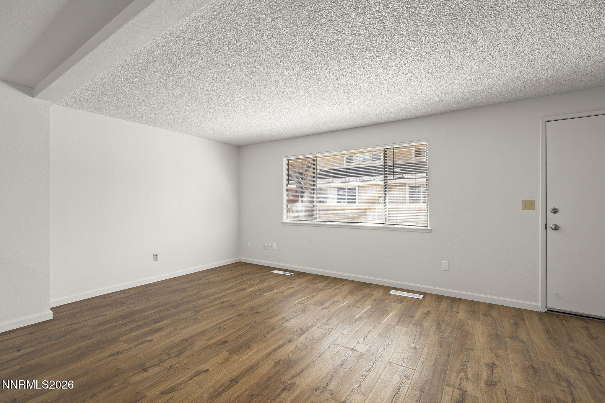 401 Allouette Way, Unit 2 Carson City, NV 89701 - Photo 8 of 29 an empty room with wooden floor and windows