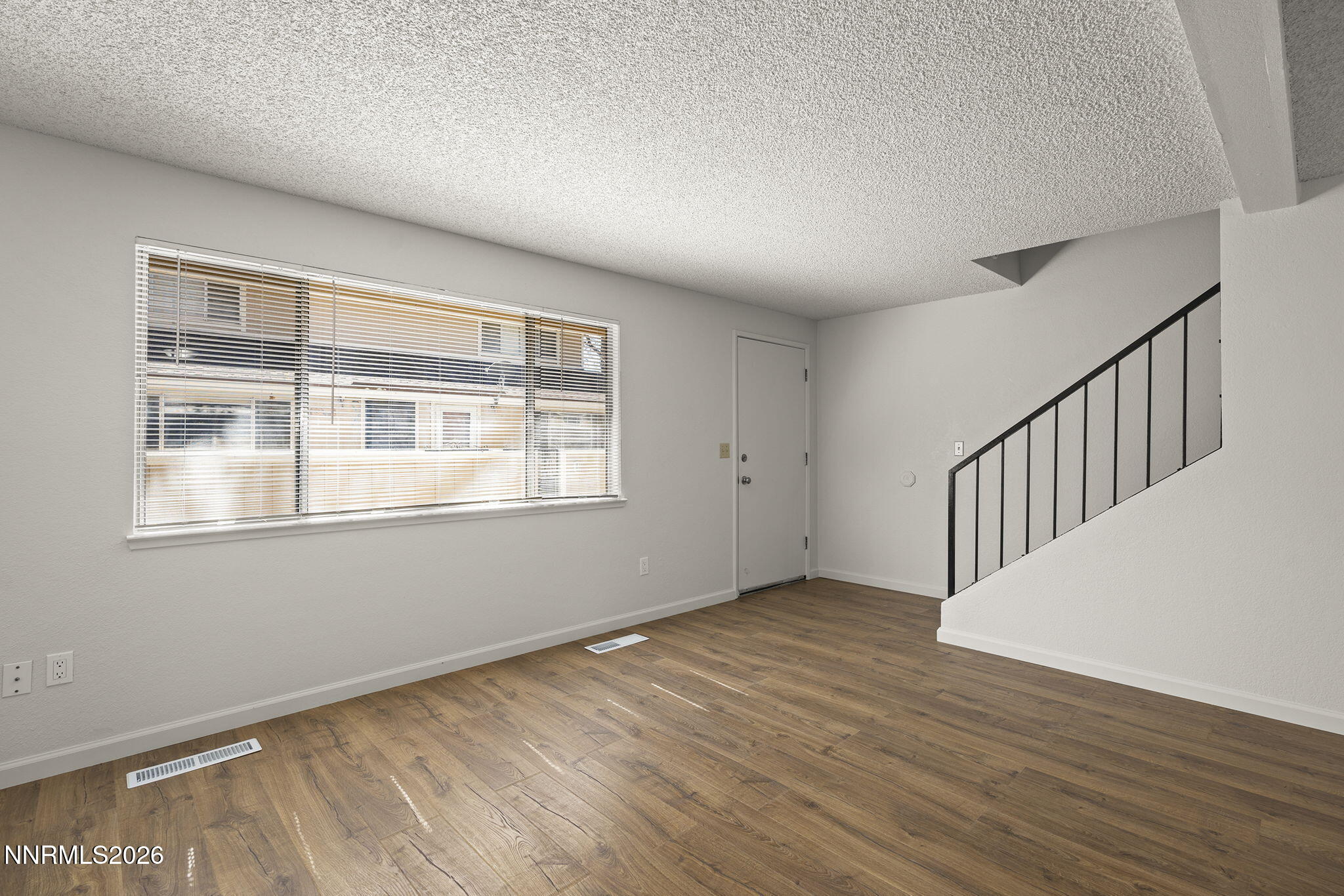 401 Allouette Way, Unit 2 Carson City, NV 89701 - Photo 9 of 29 a view of an empty room with wooden floor and a window