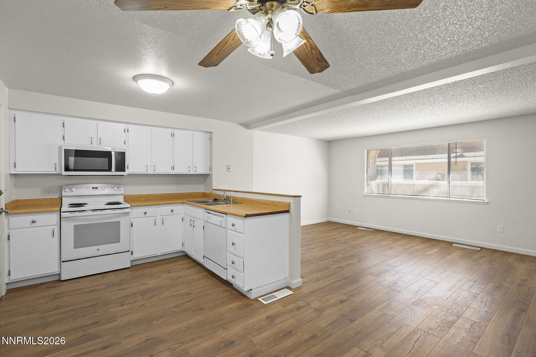 401 Allouette Way, Unit 2 Carson City, NV 89701 - Photo 10 of 29 a kitchen with granite countertop white cabinets and white appliances
