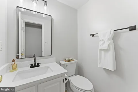 a sign that is sitting in front of flowers