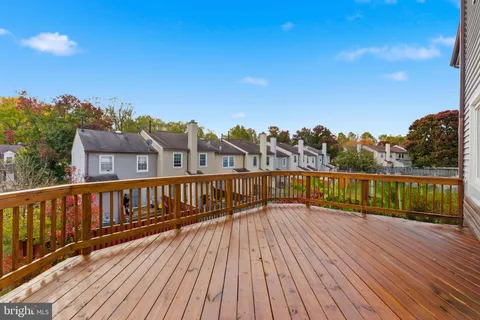 a view of balcony with wooden floor and fence