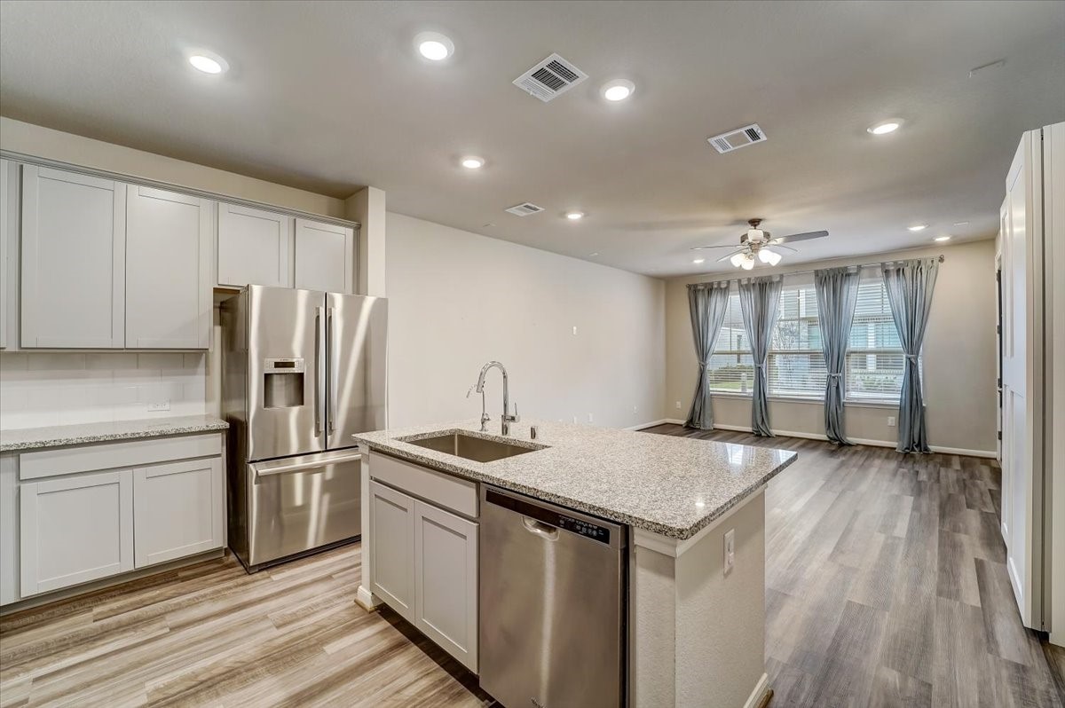 9438 Caddo Ridge Lane Cypress, TX 77433 - Photo 12 of 38 Open-concept kitchen and living area which is great for maximizing space and for entertaining!