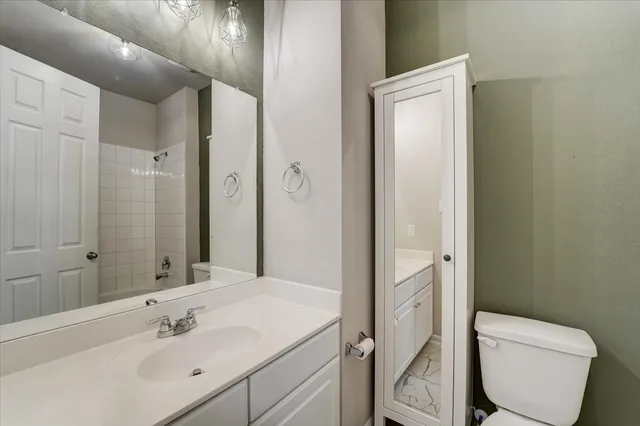 a bathroom with a toilet sink and shower