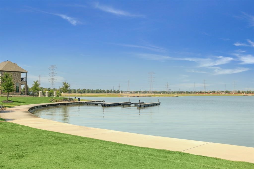 9438 Caddo Ridge Lane Cypress, TX 77433 - Photo 31 of 38 There are day docks for your boat and a walking trail all around the lake!
