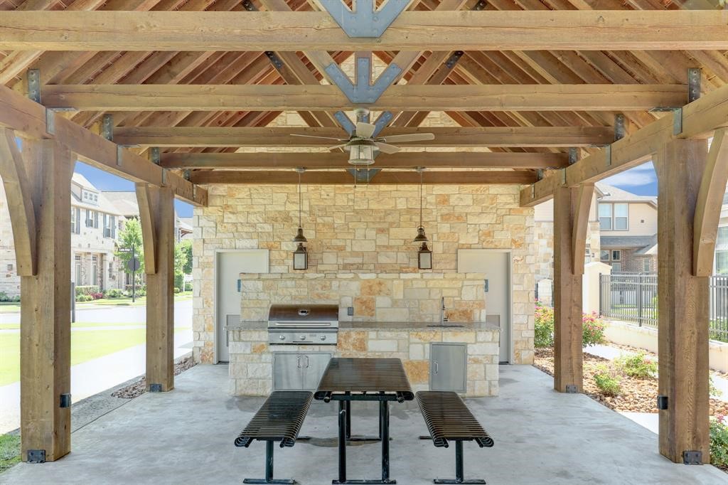 9438 Caddo Ridge Lane Cypress, TX 77433 - Photo 35 of 38 A charming outdoor pavilion with a rustic wooden roof and stone walls. It features a built-in grill as well!