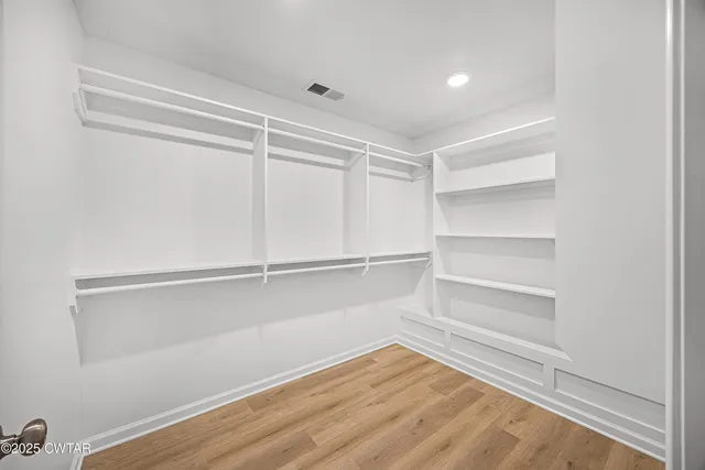 a view of an empty walk in closet
