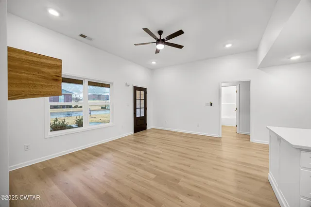 a view of an empty room with a window