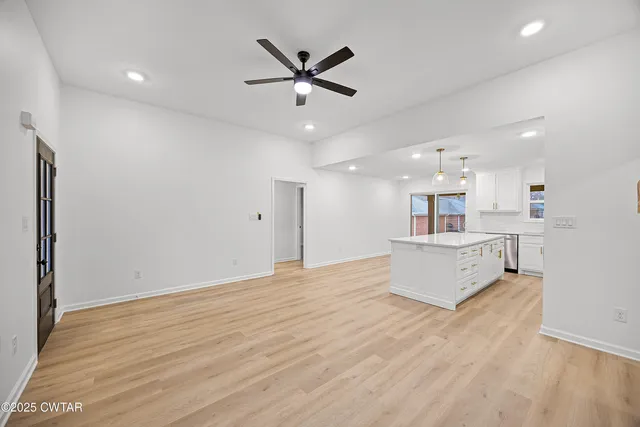 a view of a kitchen with a sink and a refrigerator