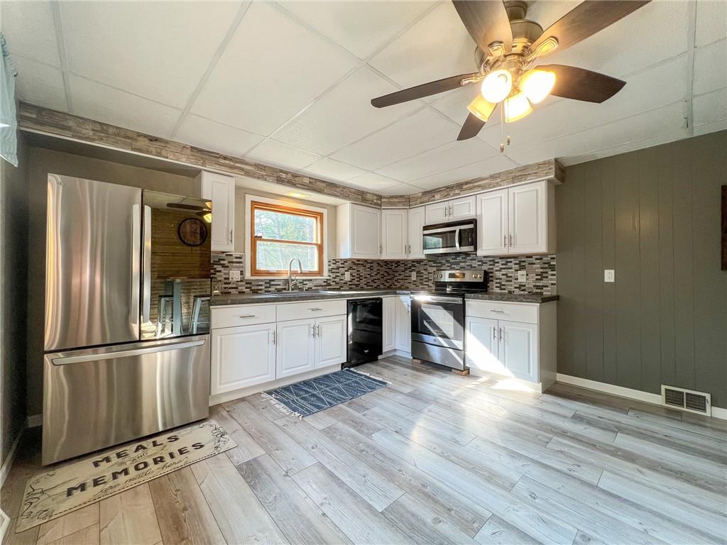 435 Grubb Road Boyers, PA 16020 - Photo 6 of 37 a kitchen with granite countertop stainless steel appliances and wooden floor