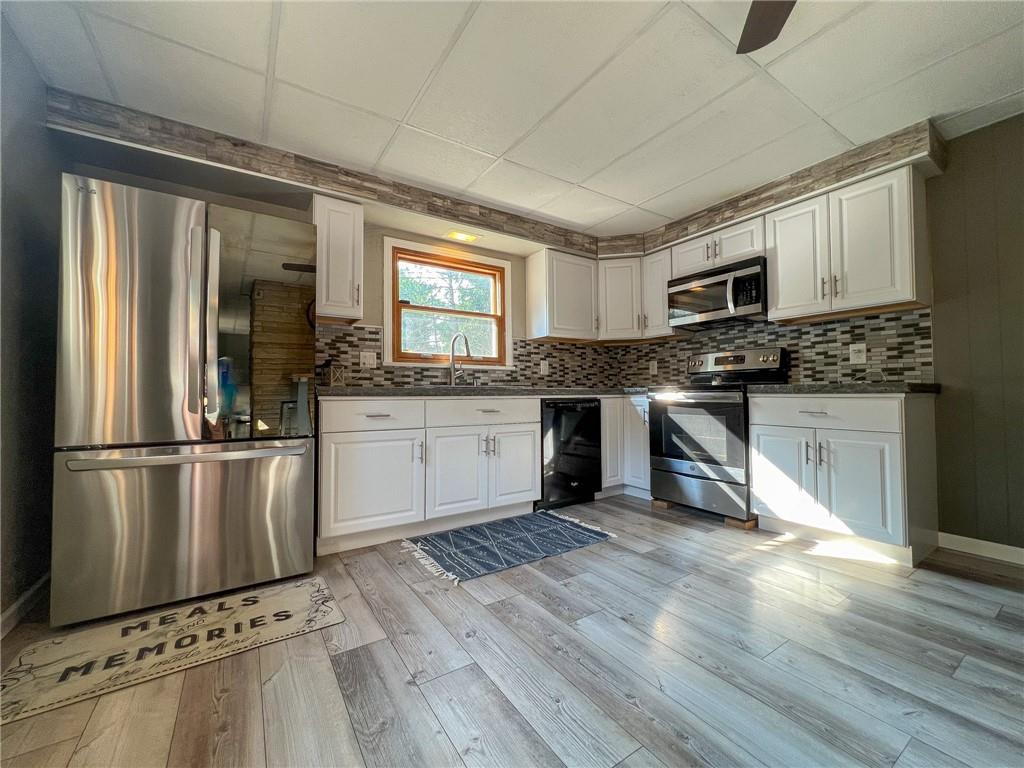 435 Grubb Road Boyers, PA 16020 - Photo 8 of 37 a kitchen with stainless steel appliances granite countertop a stove top oven a sink and a refrigerator