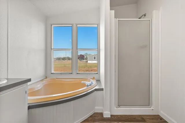 a bathroom with a tub and shower