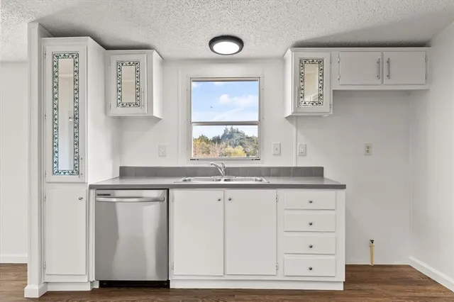 a kitchen with granite countertop a sink and a window