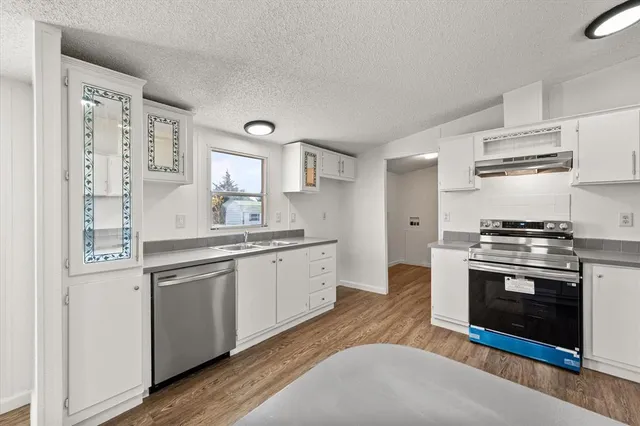 a kitchen with stainless steel appliances granite countertop a stove and a sink