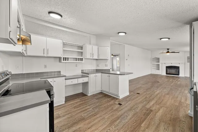 a kitchen with a sink cabinets and wooden floor