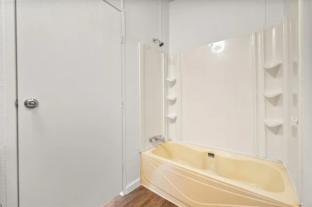 a bathroom with a tub and shower
