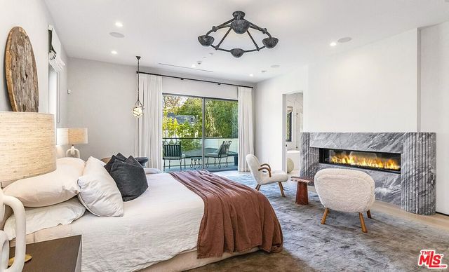 a bedroom with a bed and ceiling fan