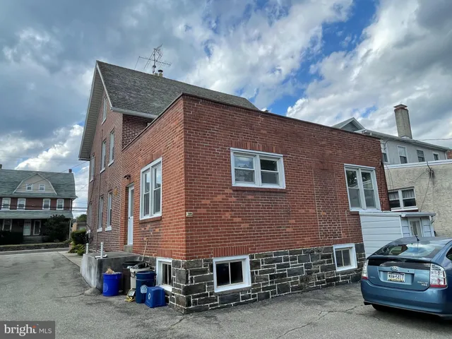 a car parked in front of a brick building