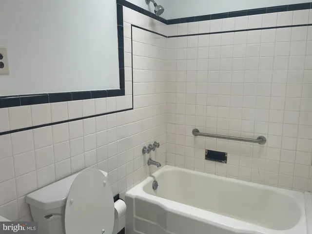 a bathroom with a white bath tub and a shower