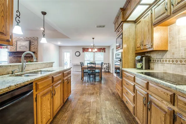 a kitchen with counter top space cabinets and wooden floor