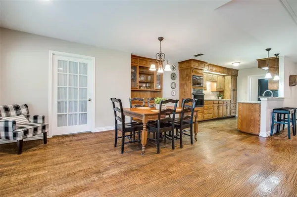 a view of a dining room with furniture and chandelier
