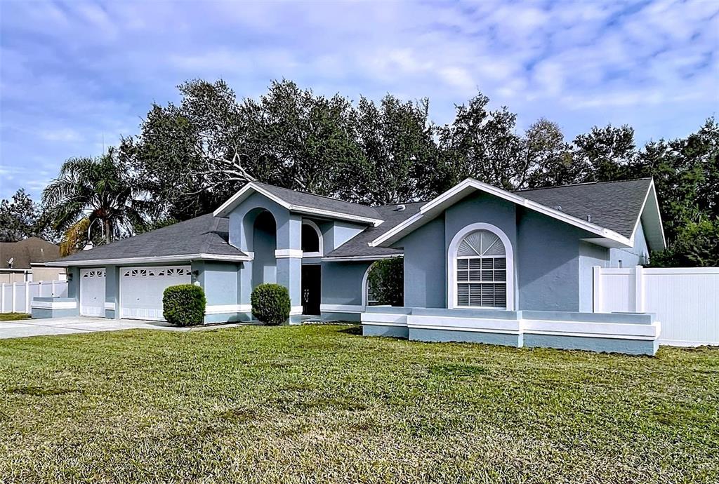 18812 Bascomb Lane Hudson, FL 34667 - Photo 5 of 57 a front view of a house with garden