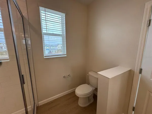 a white toilet sitting next to a sink