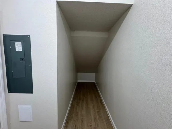 a view of a hallway with wooden floor