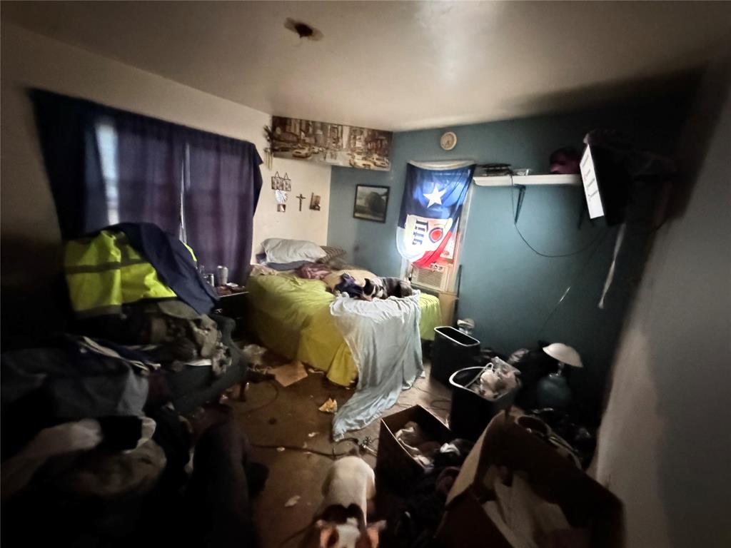 5054 Flamingo Road Fort Worth, TX 76119 - Photo 11 of 15 a bedroom with a bed next to a window